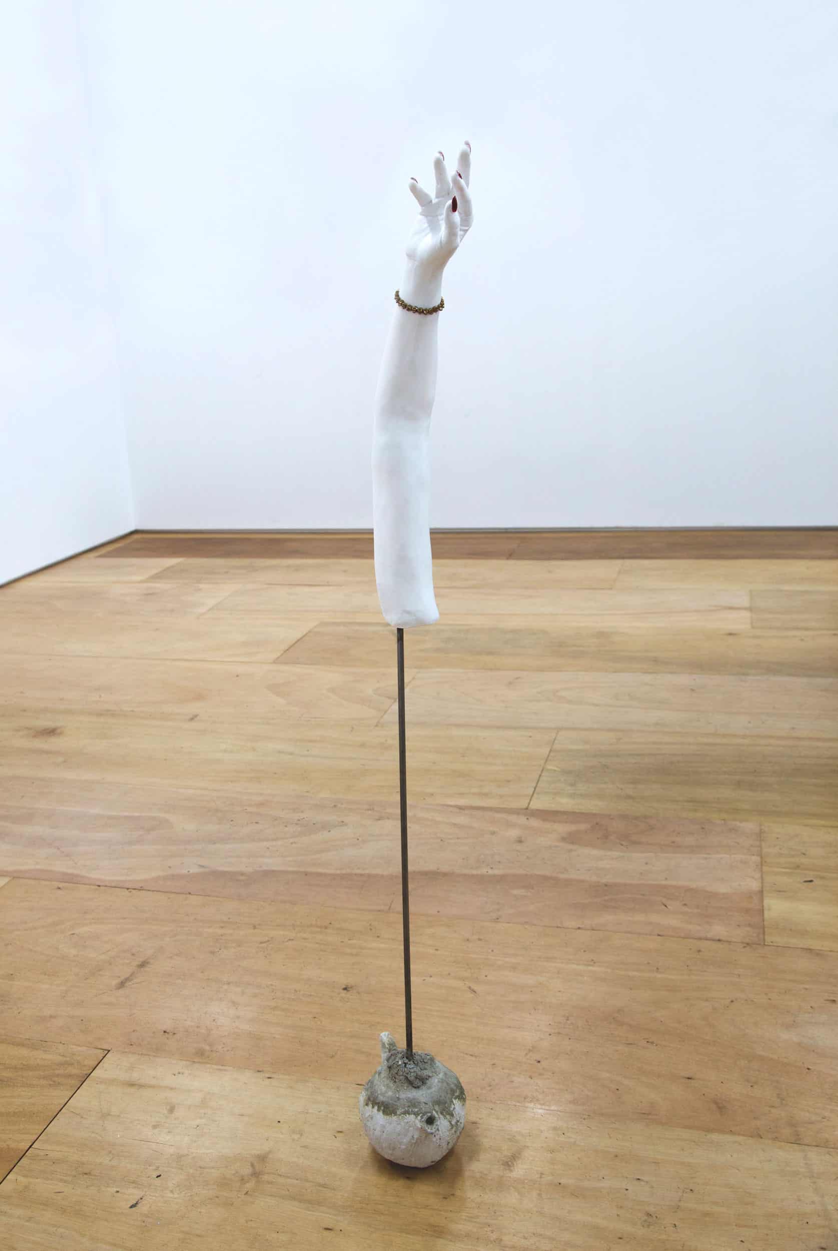 Anna Perach, Hand,155×29cm, Plaster, metal pole, cement, nail polish, porcelain, baby teeth casting, 2017