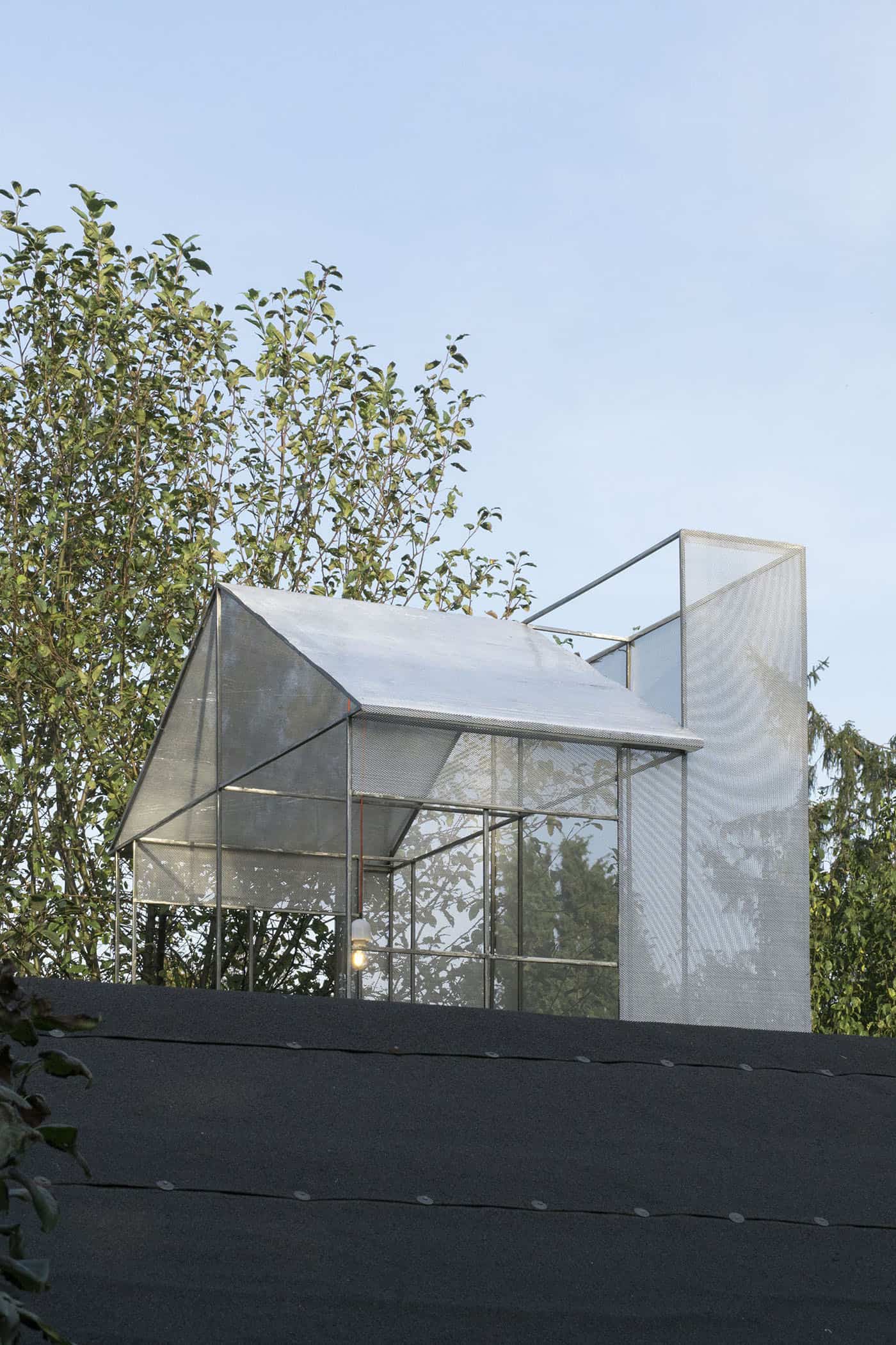 Jan Domicz, BnB, 2017, Gardening allotment. Sculpture placed on top of R.O.D. Gallery is a 1:1 model of a characteristic lantern which lets the light into highly densified tenant houses at Warsaw Old Town. Piece is built out of materials typical for fans, air conditioners and other installations visible on an office building rooftops.