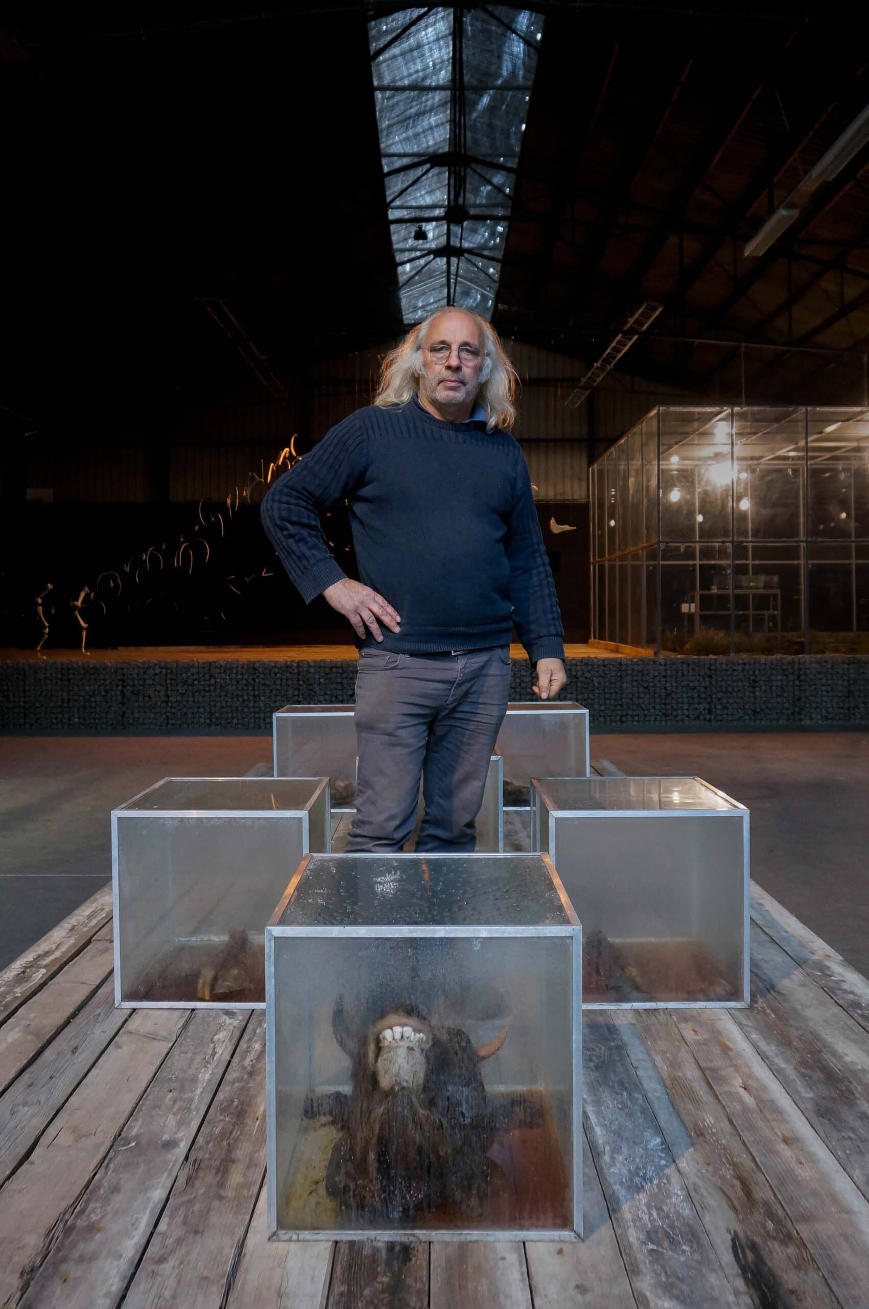 Geert Verbeke standing on Martin uit den Bogaard’s Cow (1990), The Verbeke Foundation. Photo by Marek Wolynski, Courtesy Verbeke Foundation