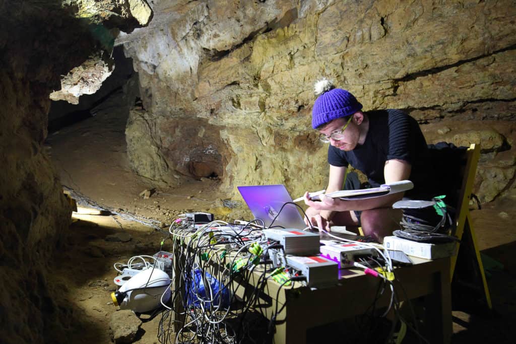 AlanJames Burn setting up Enitrely hollow aside from the dark inside Creswell Crags Caves, September 2019, Photo Marek Wolynski