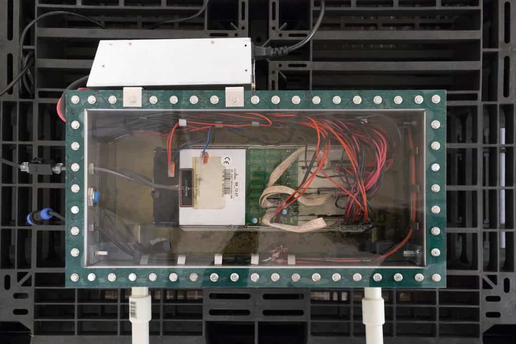 Jan Domicz, Untitled (Greenhouse 18m2) 2019, AntMiner, internet connection, oil, pump, heaters, HeatMiner, foil, pcv pipes, sliding doors