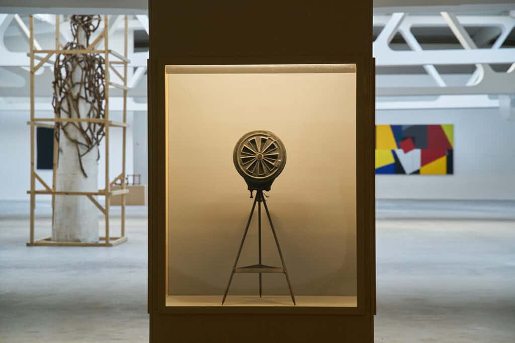 Exhibition view Front: Manual fire alarm 20th cent. metal Museum of the Highland Banat, Reșița Back from left to right: Napoleon Tiron Human as a Spatial Drawing, 1985 wood, plaster, cloth, string, 303 x 106 x 70 cm The National Museum of Contemporary Art, Bucharest Cristian Dițoiu Stage-lighting X20, 2020 oil on canvas, 146 x 459 cm, courtesy of the artist