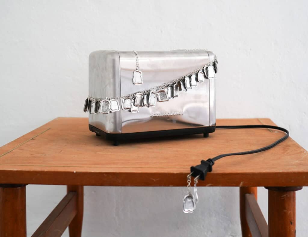 Ty Locke, Breaded toaster, 2025. Toaster, hand embossed tin. silver plated chain. 20 x 36 x 17 cm. Courtesy of the Artist and Copperfield, London. Copyright the Artist_