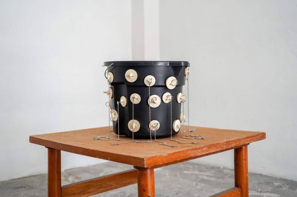 Ty Locke, Plugged bucket, 2025. Bucket, plugs, chains. 27 x 33 x 31 cm. Courtesy of the Artist and Copperfield, London. Copyright the Artist.