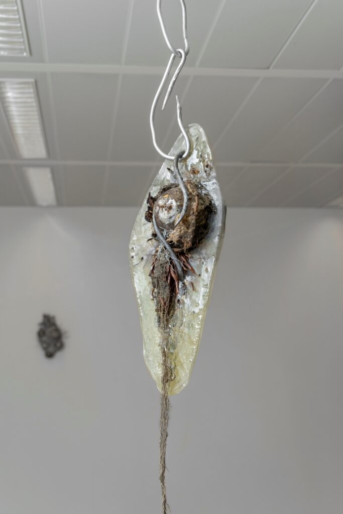 Ivy Chilelli, Bones and Flowers, 2023, resin, iron, plants, flowers, fabric, 150x40x30cm. Installation view at BiM, spaces of Specific, curated by Pessima, 2023. Courtesy of the artist