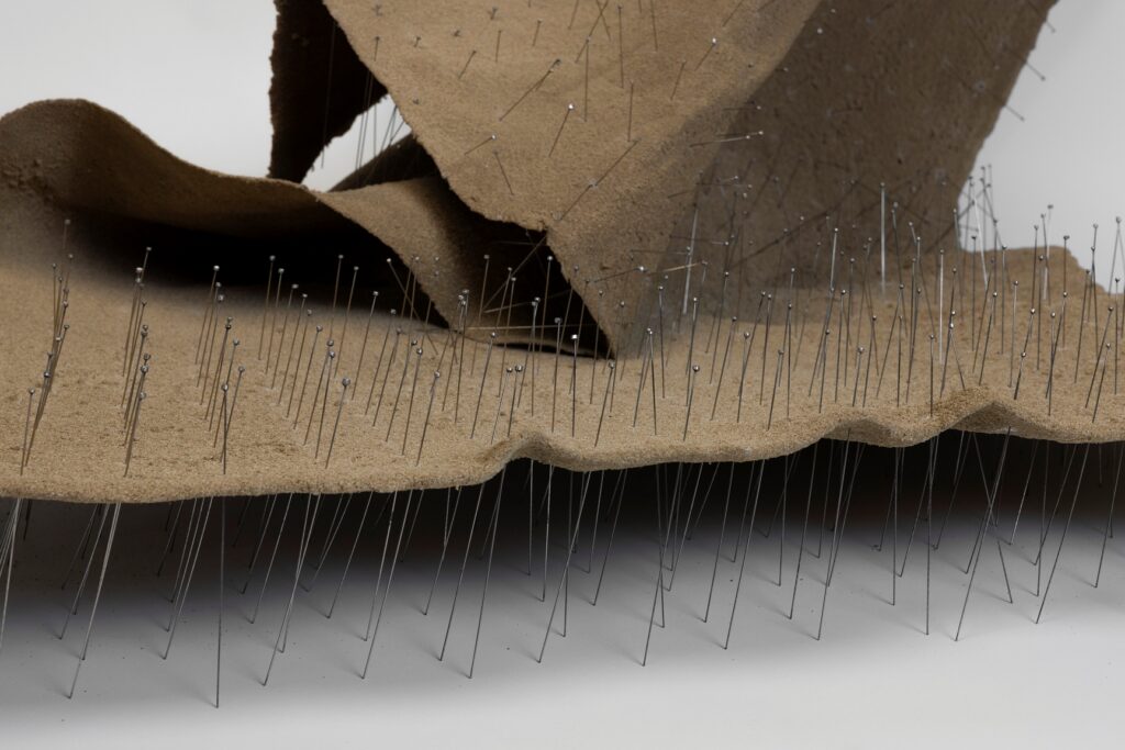 Talin Hazbar, Recline, 2025. Sand, fiberglass, pins, 120x110x140 cm. Courtesy of AWL and the artist. Photo credit_ Ismail Noor at Seeing Things.